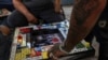 FILE - A player moves his piece in poleana, a board game invented in prison, during a tournament in Mexico City, Nov. 17, 2024. 