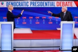FILE - Former Vice President Joe Biden, left, and Sen. Bernie Sanders, I-Vt., right, participate in a Democratic presidential primary debate at CNN Studios in Washington, March 15, 2020.