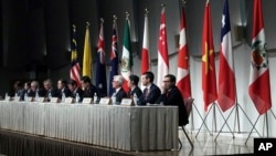 FILE - Officials representing countries of the Pacific Rim trade bloc attend a joint press conference after a session of the Comprehensive and Progressive Agreement for Trans-Pacific Partnership (CPTPP) in Tokyo, Japan, Jan. 19, 2019. 