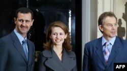 (FILES) Syrian President Bashar al-Assad (L) poses with his wife Asma (C) and Britain's Prime Minister Tony Blair (R) outside No.10 Downing Street in London 16 December 2002.