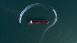 In this July 21, 2019 photo, an aerial view shows a speedboat of Iran's Revolutionary Guard moving around the British-flagged oil tanker Stena Impero which was seized in the Strait of Hormuz by the Guard, in the Iranian port of Bandar Abbas.