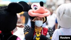 A woman costumed as Minnie Mouse wears a mask to prevent against the spread of coronavirus disease (COVID-19), as the highly transmissible Delta variant has led to a surge in infections, in New York City, U.S., July 30, 2021. 