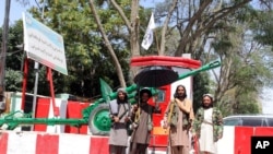 Taliban fighters stand guard inside the city of Ghazni, southwest of Kabul, Afghanistan, Aug. 13, 2021. 