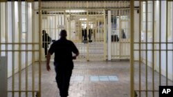 FILE - A guard walks in the corridor of Fresnes prison, south of Paris, France, Sept. 20, 2016.