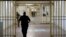 FILE - A guard walks in the corridor of Fresnes prison, south of Paris, France, Sept. 20, 2016.
