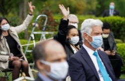 Members of the White House press corps wear protective face masks as U.S. President Donald Trump holds a coronavirus disease outbreak response press briefing in the Rose Garden of the White House in Washington, May 11, 2020.