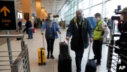 Passengers arrive at the Jorge Chavez International Airport in Callao, Peru, Monday, Oct. 5, 2020. After international flights were halted for more than six months amid the COVID-19 pandemic.