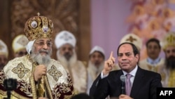 Le président égyptien Abdel Fattah al-Sisi, à droite, parle près du pape copte Tawadros II lors d'une messe de Noël à la cathédrale de la Nativité du Christ dans la nouvelle capitale administrative égyptienne, à 45 km à l'est du Caire, le 6 janvier 2018.