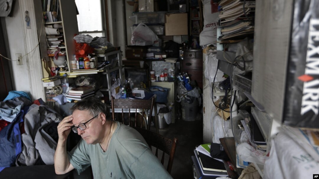 FILE - A man pictured in his cluttered home.