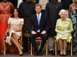 FILE -- Queen Elizabeth, Prince Harry and Meghan, the Duchess of Sussex, pose for a picture at in London, Britain, June 26, 2018.