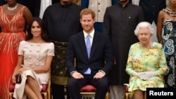 FILE - Britain's Queen Elizabeth, Prince Harry and Meghan, the Duchess of Sussex, pose for a picture in London, Britain, June 26, 2018.