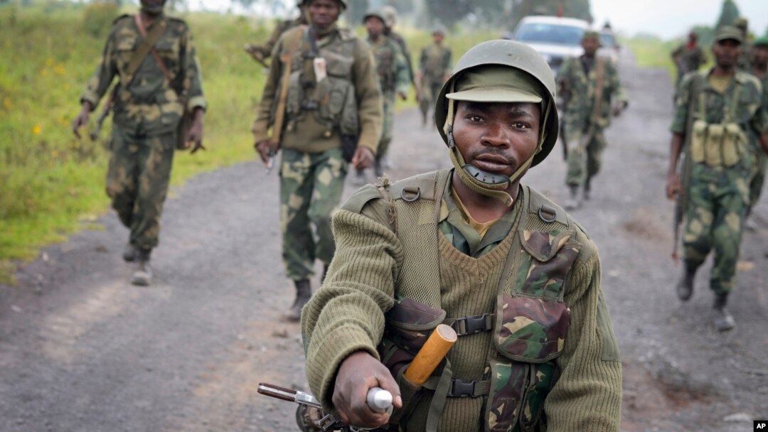 Tentara Kongo berbaris menuju kota Kibumba setelah merebutnya dari pemberontak M23 (28/10). (AP/Joseph Kay)