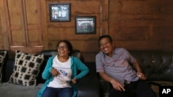 Ni Luh Erniati, left, laughs with Ali Fauzi during her visit to Fauzi's house in Tenggulun, East Java, 2019. Erniati's husband was killed in 2002 Bali bombings.