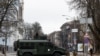 Ukrainian military service members guard a road in Kyiv