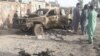 Residents look at an Army vehicle which was damaged during battle between Afghan security forces and Taliban in Farah province, Afghanistan, May 16, 2018. 