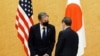 Japanese Prime Minister Yoshihide Suga, right, meets with US Secretary of State Antony Blinken during a courtesy call at the prime minister's official residence, March 16, 2021.