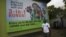 A man walk past a giant advertisement bill board of Nigeria Globacom in Lagos, Nigeria, May, 13. 2012.