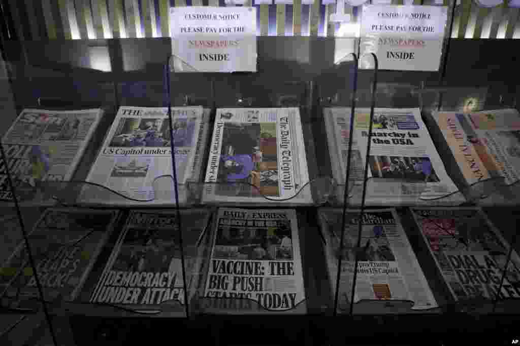 British national newspapers, with front pages reporting on the mob loyal to President Donald Trump storming the U.S. Capitol, are seen for sale outside a store in London.