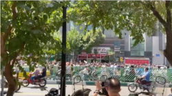 In this screen grab from video shared on social media, Iranians march chanting anti-government slogans on a street in central Tehran, July 26, 2021.