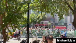 In this screen grab from video shared on social media, Iranians march chanting anti-government slogans on a street in central Tehran, July 26, 2021.