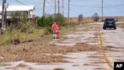 Resident Bill Andrews walks to a store 1.5 miles away to see if he can get gas, after Hurricane Francine flooded his truck, in Cocodrie, Louisiana, Sept. 12, 2024.