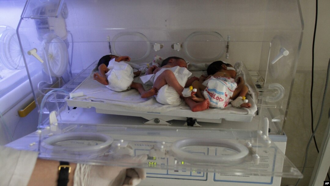 In this May 7, 2015 photo, new born Afghan babies are seen at Indira Gandhi children's hospital, and neonatal ward in Kabul, Afghanistan.