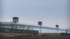 FILE - Guard towers are seen along the perimeter wall of the Urumqi No. 3 Detention Center in Dabancheng in western China's Xinjiang Uyghur Autonomous Region, April 23, 2021.