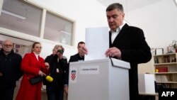 Croatia's President Zoran Milanovic casts his ballot to vote in the country's parliamentary elections at a polling station in Zagreb on April 17, 2024.