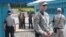 FILE - North Korean army soldiers watch the south side while South Korean, left, and U.S. Army soldiers stand guard at the truce villages of Panmunjom in Paju, South Korea, July 27, 2014.