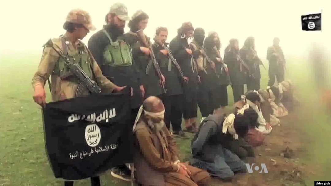 FILE - Image from purported Islamic State group video shows captives.