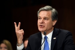 FILE - FBI Director Christopher Wray testifies before the Senate Judiciary Committee on Capitol Hill in Washington, July 23, 2019.