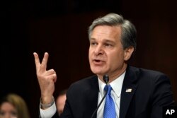 FILE - FBI Director Christopher Wray testifies before the Senate Judiciary Committee on Capitol Hill in Washington, July 23, 2019.