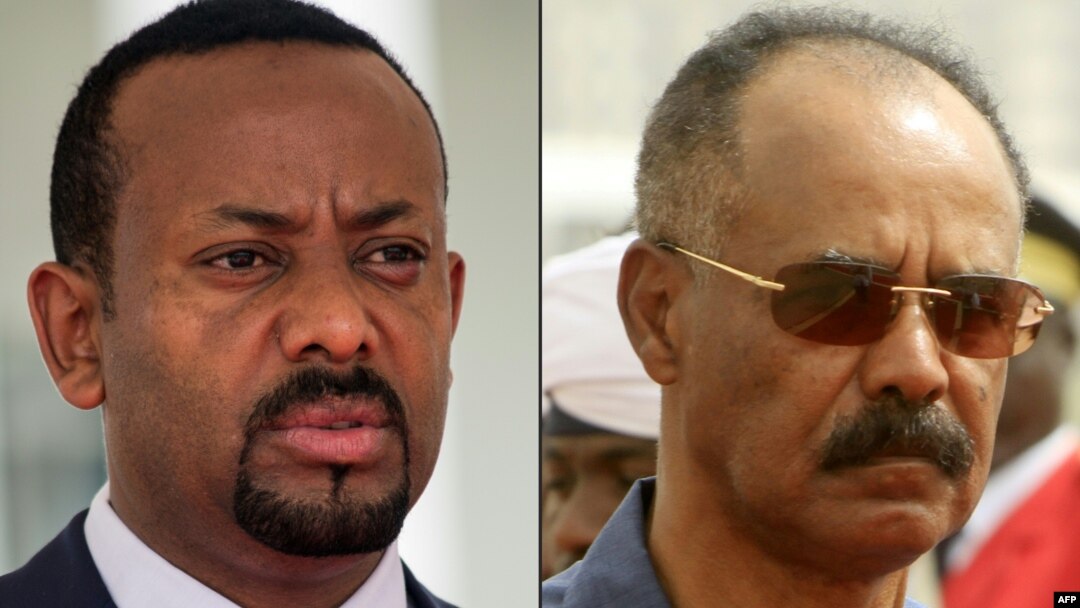This combination of file pictures Ethiopian Prime Minister Abiy Ahmed, left, in Entebbe, Uganda, June 8, 2018 and Eritrean President Isaias Afwerki reviewing the honor guard during his welcome ceremony in the Khartoum, Sudan, June 11, 2015.
