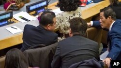 FILE - North Korean officials are seen conferring during a meeting of the U.N. General Assembly human rights committee Nov. 18, 2014.