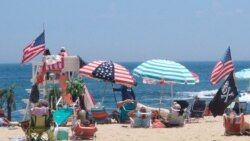 Flags line the beach in Belmar, N.J., on June 28, 2020. With large crowds expected at the Jersey Shore for the July Fourth weekend, some are worried that a failure to heed mask-wearing and social distancing protocols could accelerate the spread of…