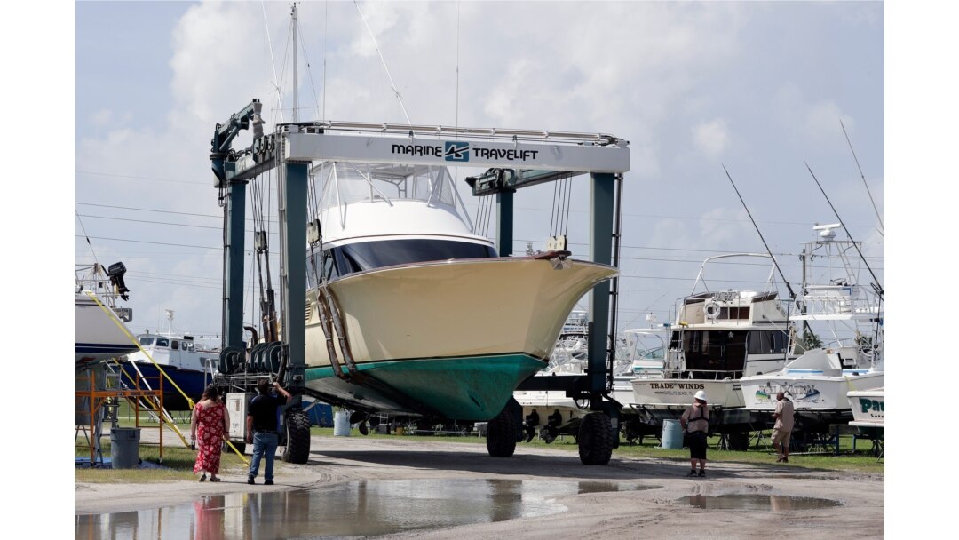 A large boat is moved to a storage lot on dry land at a marina in Cape Canaveral, Fla., as boat owners prepare for the arrival of Hurricane Dorian, Aug. 31, 2019,