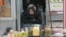 FILE - An elderly Ukrainian woman sells home made products  in downtown Kyiv, Ukraine, Feb. 3, 2016. 