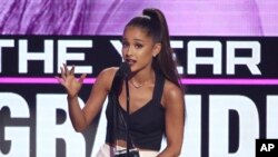 FILE - Ariana Grande accepts the award for artist of the year at the American Music Awards at the Microsoft Theater in Los Angeles, Nov. 20, 2016.