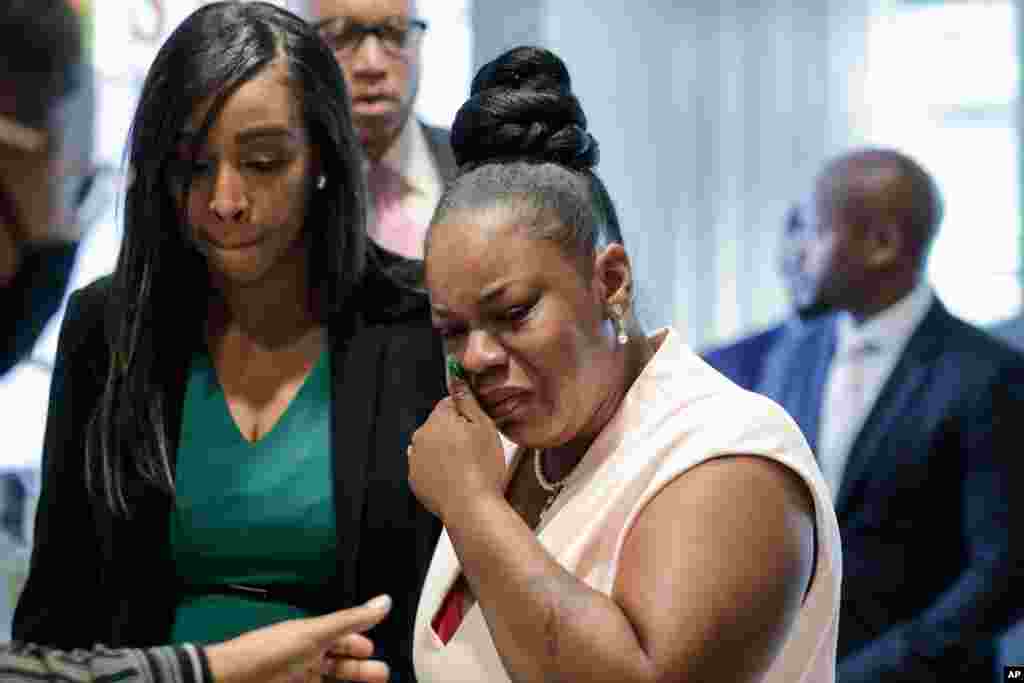 Tomika Miller, right, widow of Rayshard Brooks, who was shot fatally by police officer Garrett Rolfe, cries as she leaves a news conference, June 17, 2020, in Atlanta, Georgia.