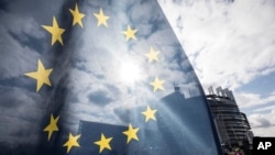 An EU flag flies at the front of the European Parliament building in Strasbourg, France, Tuesday March 26, 2019.