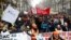 French labor union members and workers on strike attend a demonstration after 24 days of strike against French government's pensions reform plans in Paris, Dec. 28, 2019. 