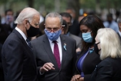 Democratic presidential candidate and former U.S. Vice President Joe Biden speaks with Senator Chuck Schumer at a ceremony for the 19th anniversary of the 9/11 attacks, in New York City, Sept. 11, 2020.
