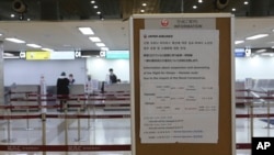 A Japan Airlines notice is displayed at Gimpo Airport in Seoul, South Korea, March 7, 2020.