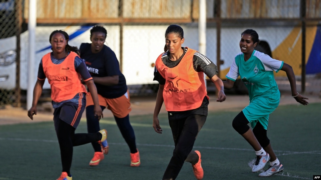 FILE - Sudanese woman football player Orjuan Essam (C), 19, takes part in a training session at a stadium in the Sudanese capital Khartoum on Nov. 20, 2019. 