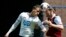 Andy Carroll (R) of West Ham United and Vlad Chiriches of Tottenham Hotspur jump for a header during the English Premier League soccer match at Upton Park in London.