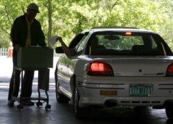 FILE - A voter casts a ballot from an auto in a special election on June 6, 2006, in Williston, Vermont.
