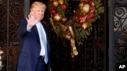 FILE - President-elect Donald Trump stands at the entrance of Mar-a-Lago, Dec. 28, 2016, in Palm Beach, Florida. 