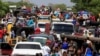 Venezuelans line up to cross into Colombia at the border in Paraguachon, Colombia, February 16, 2018. 