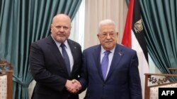 This handout picture provided by the Palestinian Press Office shows Palestinian President Mahmud Abbas (R) meeting with the Prosecutor of the International Criminal Court Karim Khan in Ramallah in the occupied West Bank on December 2, 2023.