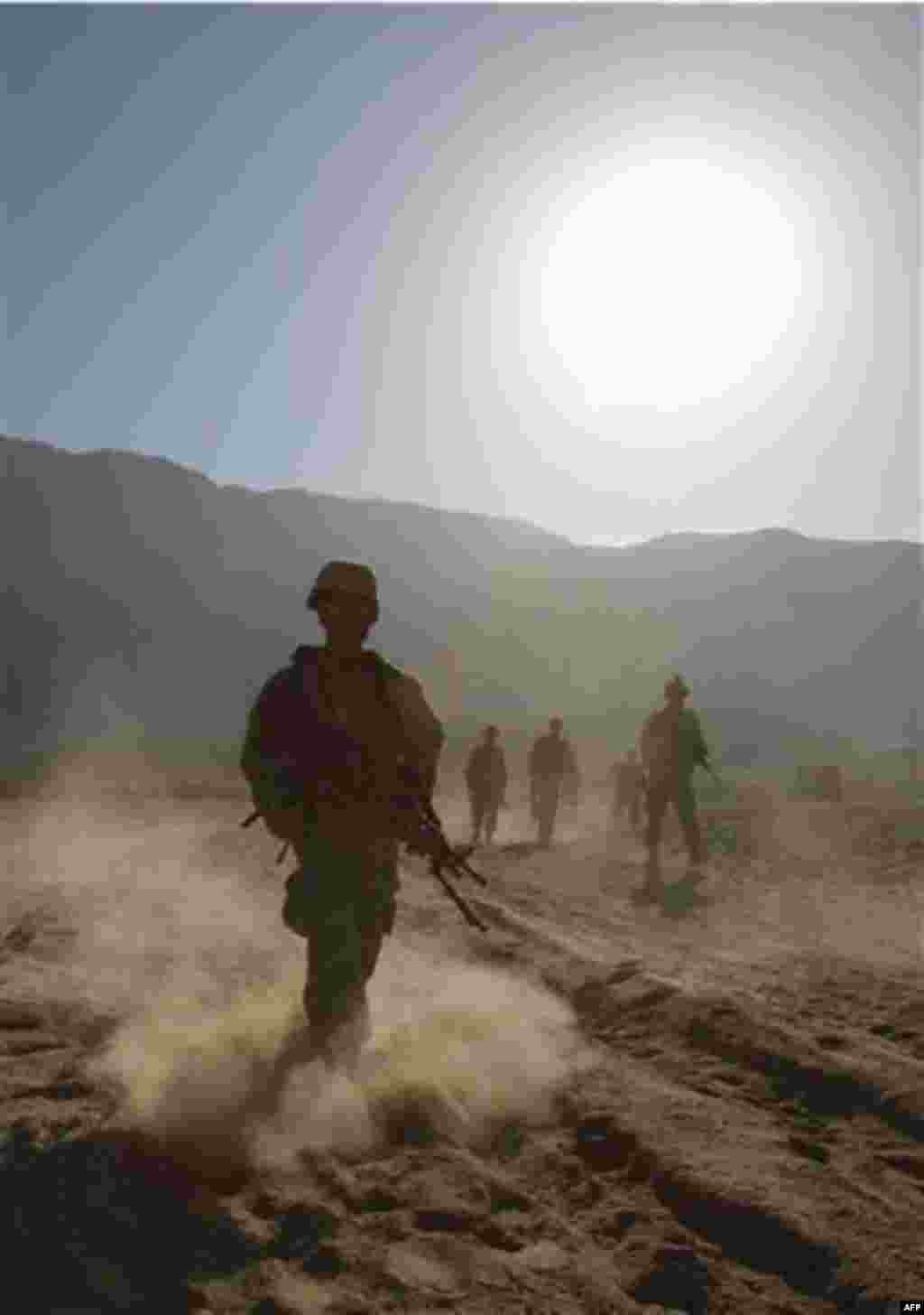 US Army Pvt. Taylor Cannon of Maine and his from from First Battalion, 502nd Infantry Regiment, 101st Airborne Division patrol in West Now Ruzi village, district Panjwai, Afghanistan, Monday, Nov. 22, 2010.(AP Photo/Alexander Zemlianichenko)